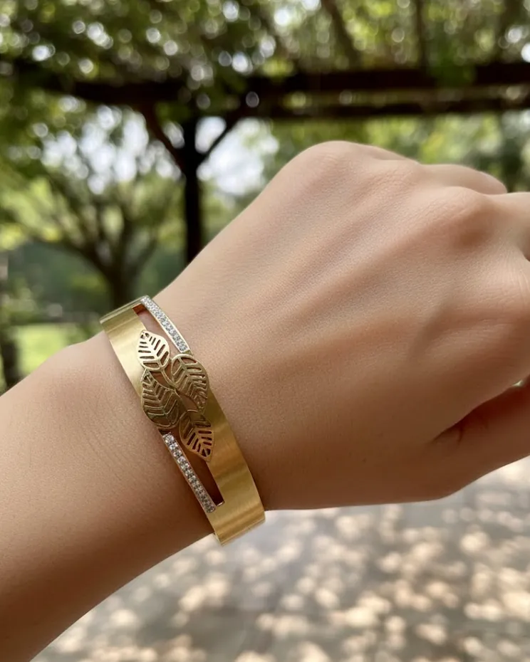 Gold-tone bangle worn on the wrist